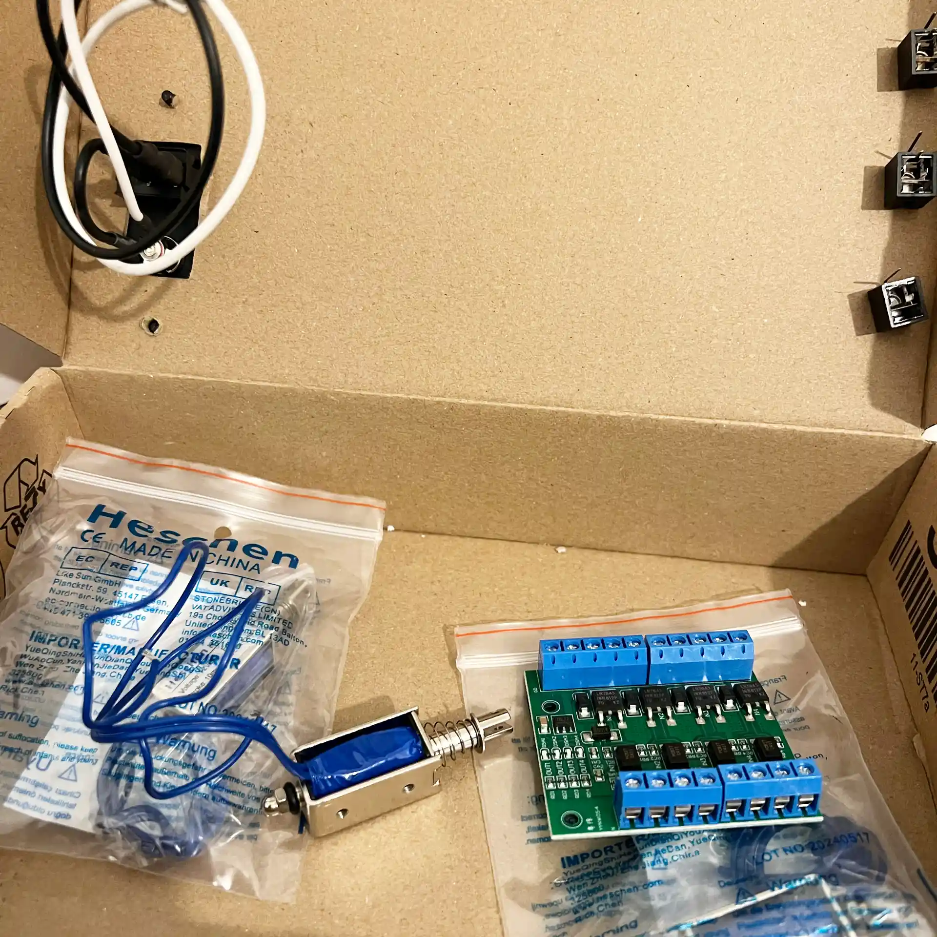 Small hardware parts in a paper box